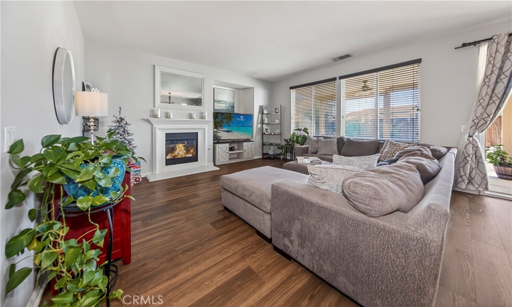 1433 Fall Brook Road Beaumont, CA 92223 - Photo 13 of 33 a spacious bedroom with a bed and a fireplace