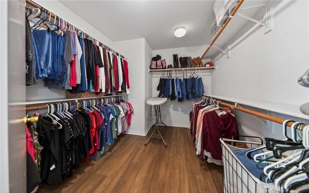 1433 Fall Brook Road Beaumont, CA 92223 - Photo 20 of 33 a view of walk in closet with clothes and shoes