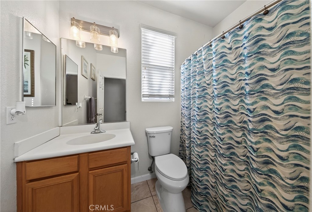 1433 Fall Brook Road Beaumont, CA 92223 - Photo 22 of 33 a bathroom with a sink toilet and shower