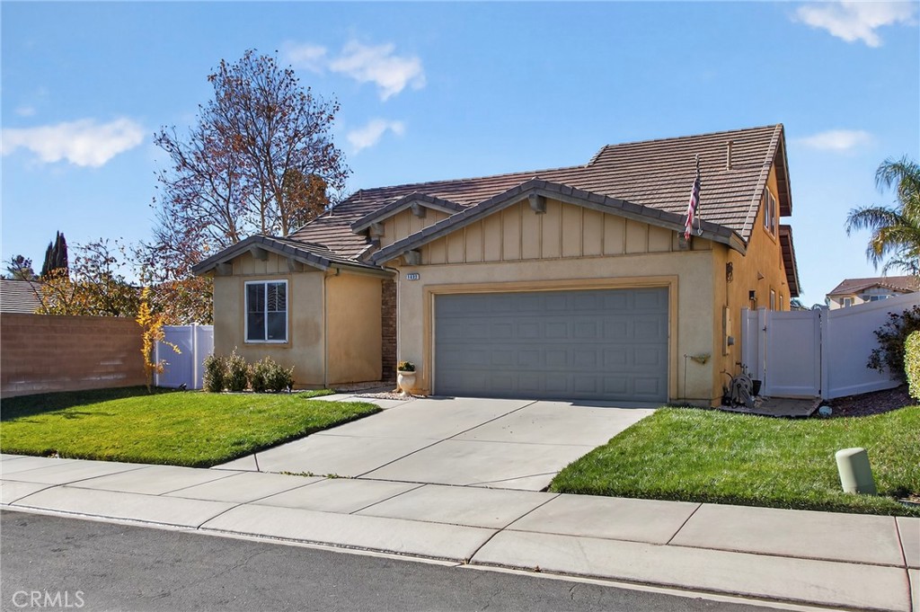 1433 Fall Brook Road Beaumont, CA 92223 - Photo 3 of 33 a front view of a house with a yard and garage