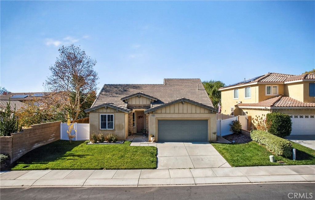 1433 Fall Brook Road Beaumont, CA 92223 - Photo 31 of 33 a front view of a house with a yard and garage