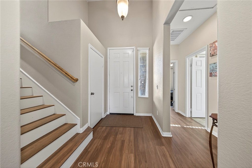 1433 Fall Brook Road Beaumont, CA 92223 - Photo 5 of 33 a view of a hallway with wooden floor and staircase