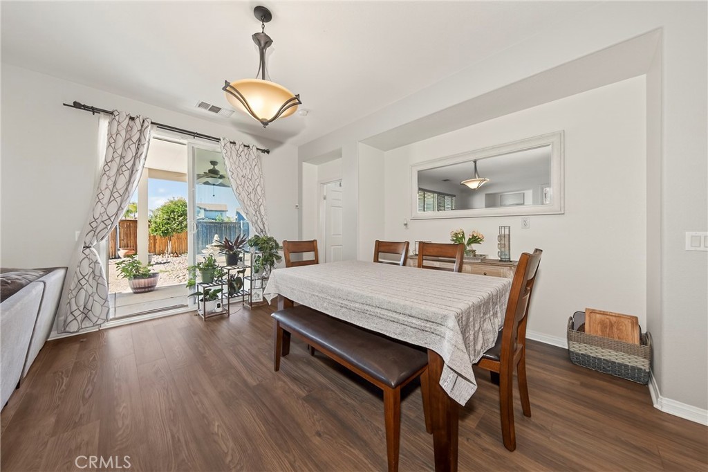 1433 Fall Brook Road Beaumont, CA 92223 - Photo 10 of 33 a view of a dining room with furniture window and wooden floor