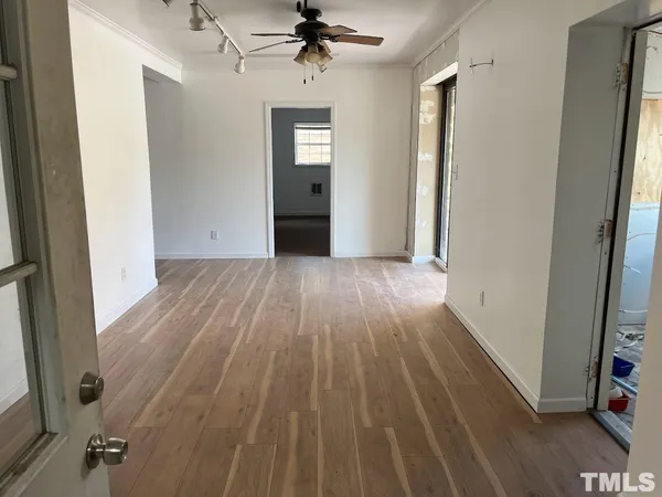 wooden floor in an empty room with a window