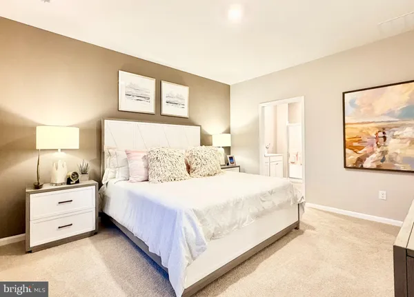 a bedroom with a bed and a night stand