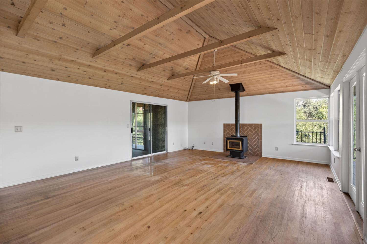 4450 Cosumnes View Trail Placerville, CA 95667 - Photo 19 of 69 a view of empty room with wooden floor and fireplace