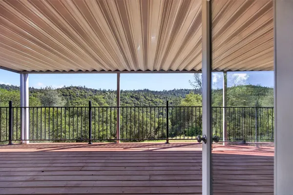 a view of a balcony with wooden floor