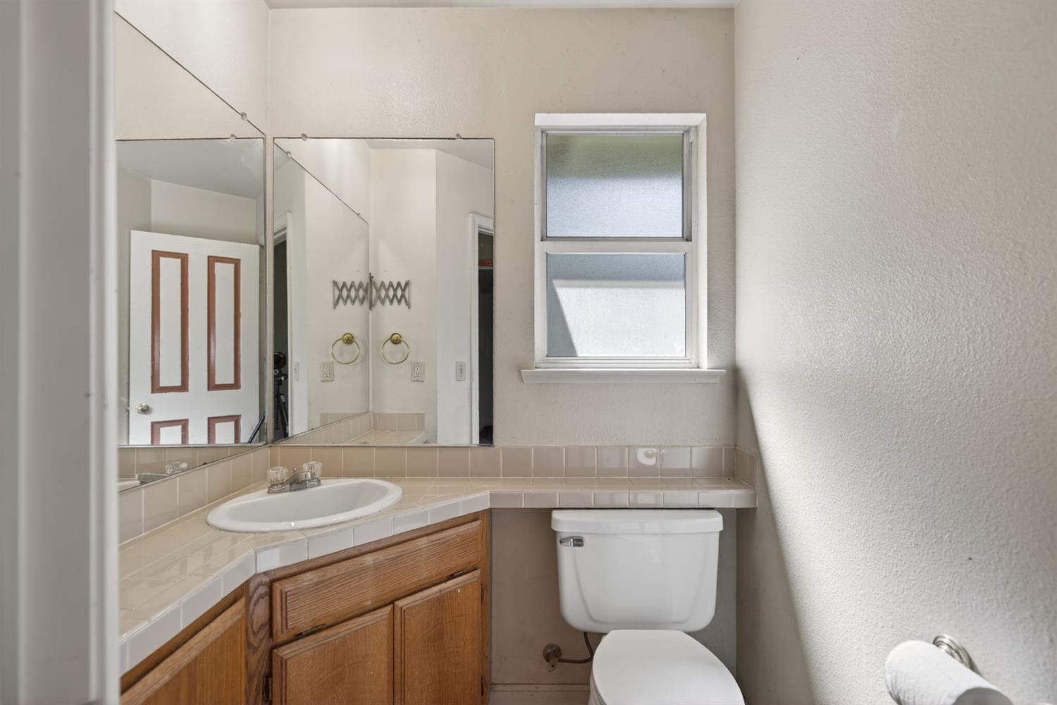 4450 Cosumnes View Trail Placerville, CA 95667 - Photo 34 of 69 a bathroom with a granite countertop sink toilet and a mirror