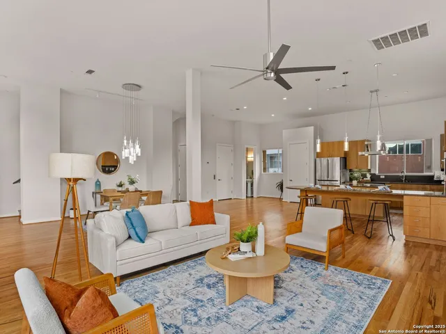 a living room with furniture and a wooden floor