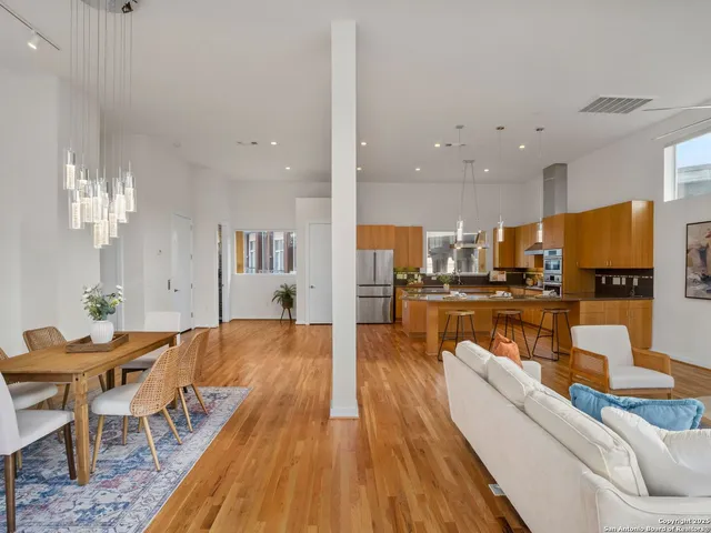 a living room with stainless steel appliances kitchen island granite countertop furniture and a kitchen view