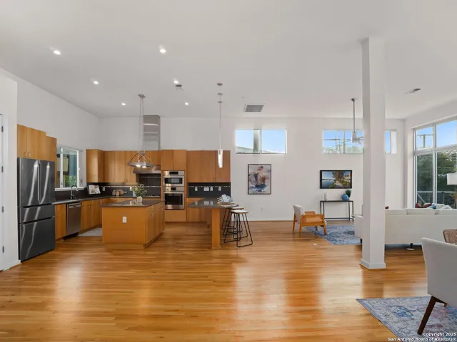 a large kitchen with lots of counter space and stainless steel appliances