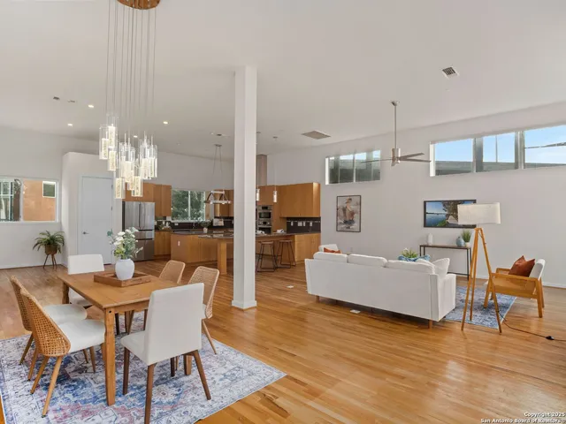 a living room with fireplace furniture and a wooden floor