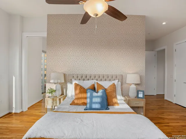 a bedroom with a bed chandelier and a window