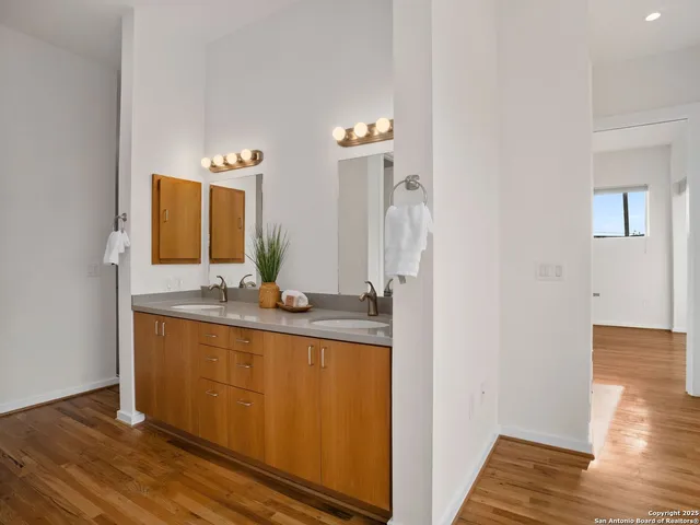a bathroom with a granite countertop sink and a mirror