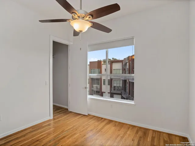 a bathroom with a granite countertop sink a toilet and a mirror
