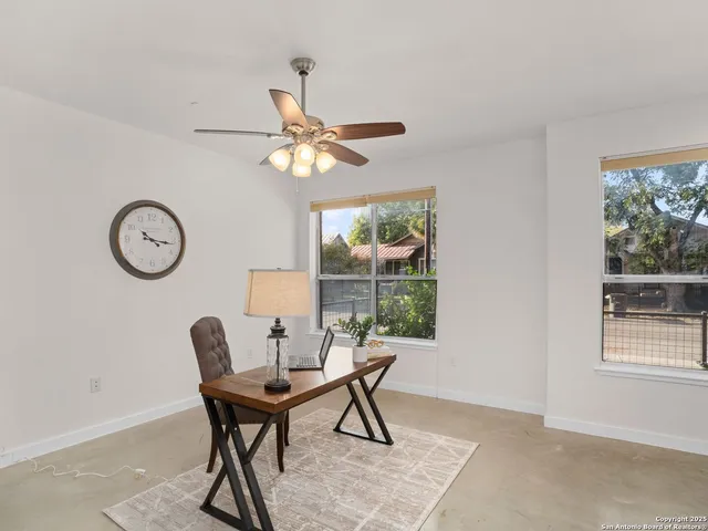 a dining room with furniture a rug and a large window