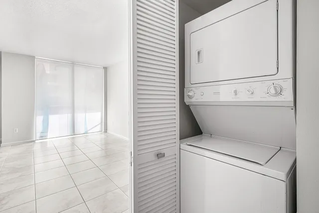 a view of washer and dryer with bathroom in the background