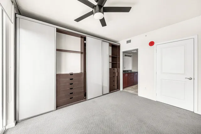 a view of an empty room with a ceiling fan
