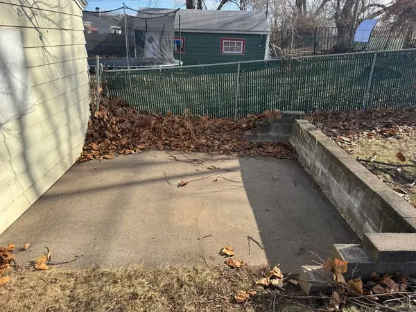 a view of a house with a wooden fence