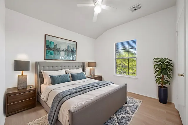 a bedroom with bed and a window