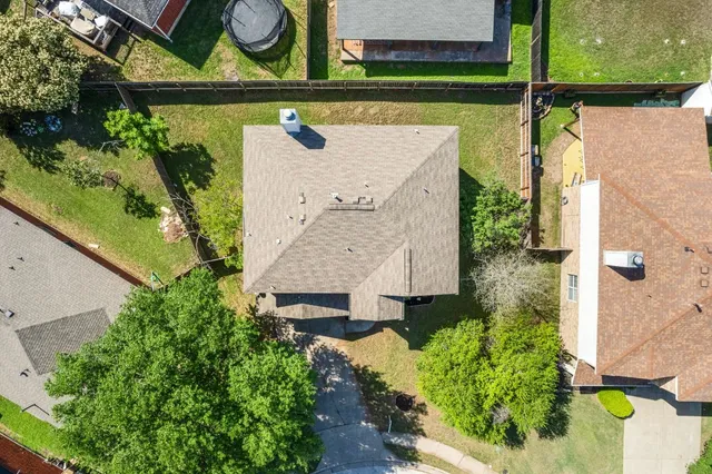 an aerial view of a house with a yard