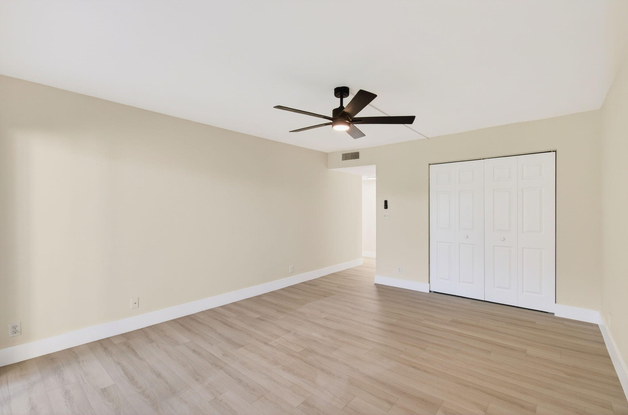 5900 Camino Del Sol, Unit 304 Boca Raton, FL 33433 - Photo 29 of 82 a view of a big room with wooden floor and a ceiling fan