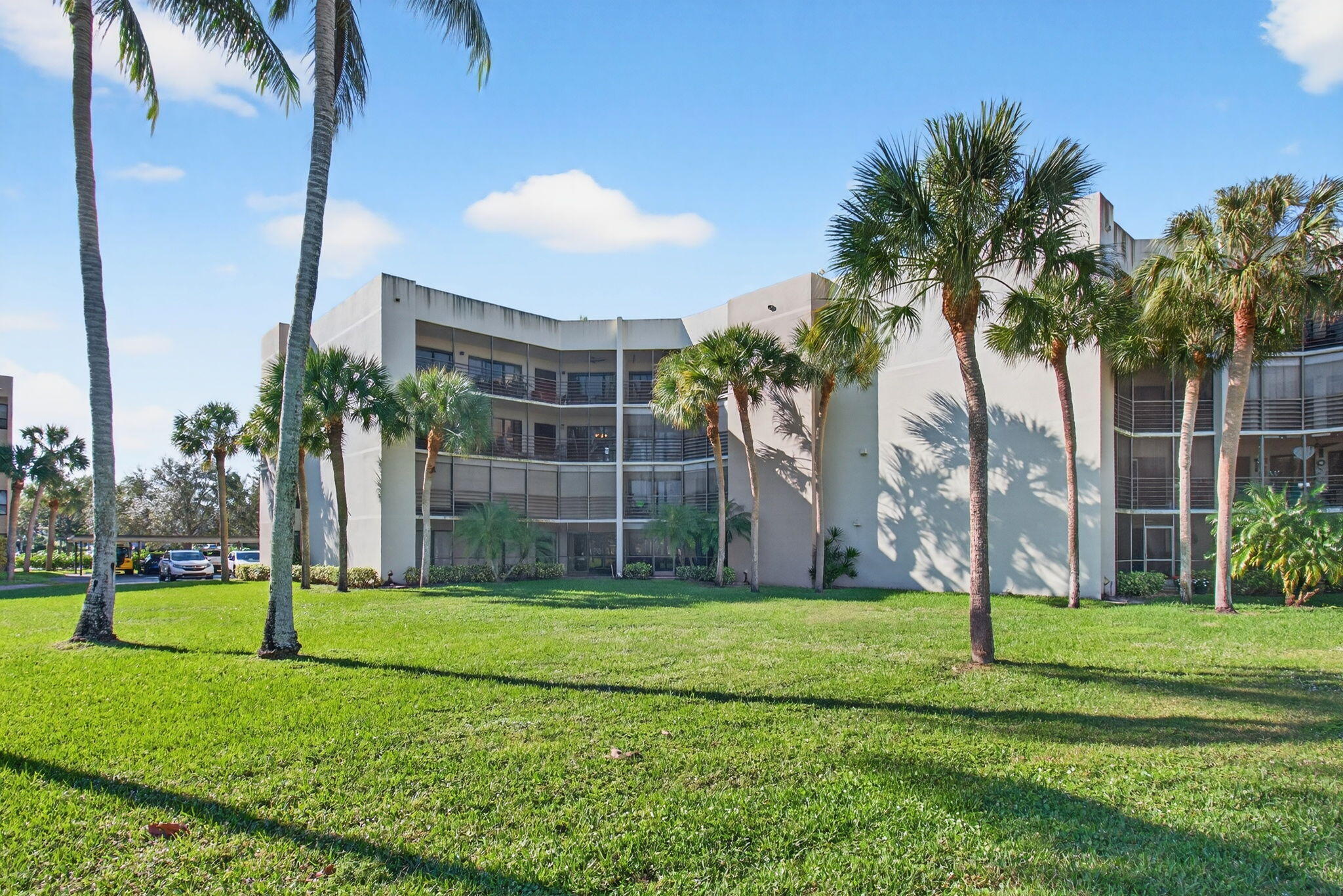 5900 Camino Del Sol, Unit 304 Boca Raton, FL 33433 - Photo 58 of 82 a view of a backyard with a garden and palm trees