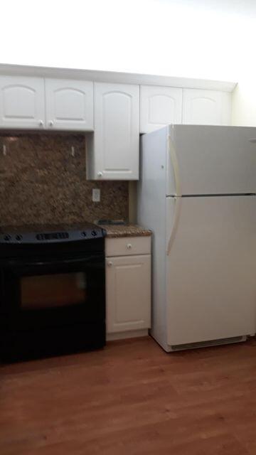 9355 Southwest 8th Street, Unit 121 Boca Raton, FL 33428 - Photo 10 of 35 a kitchen with a sink and a stove
