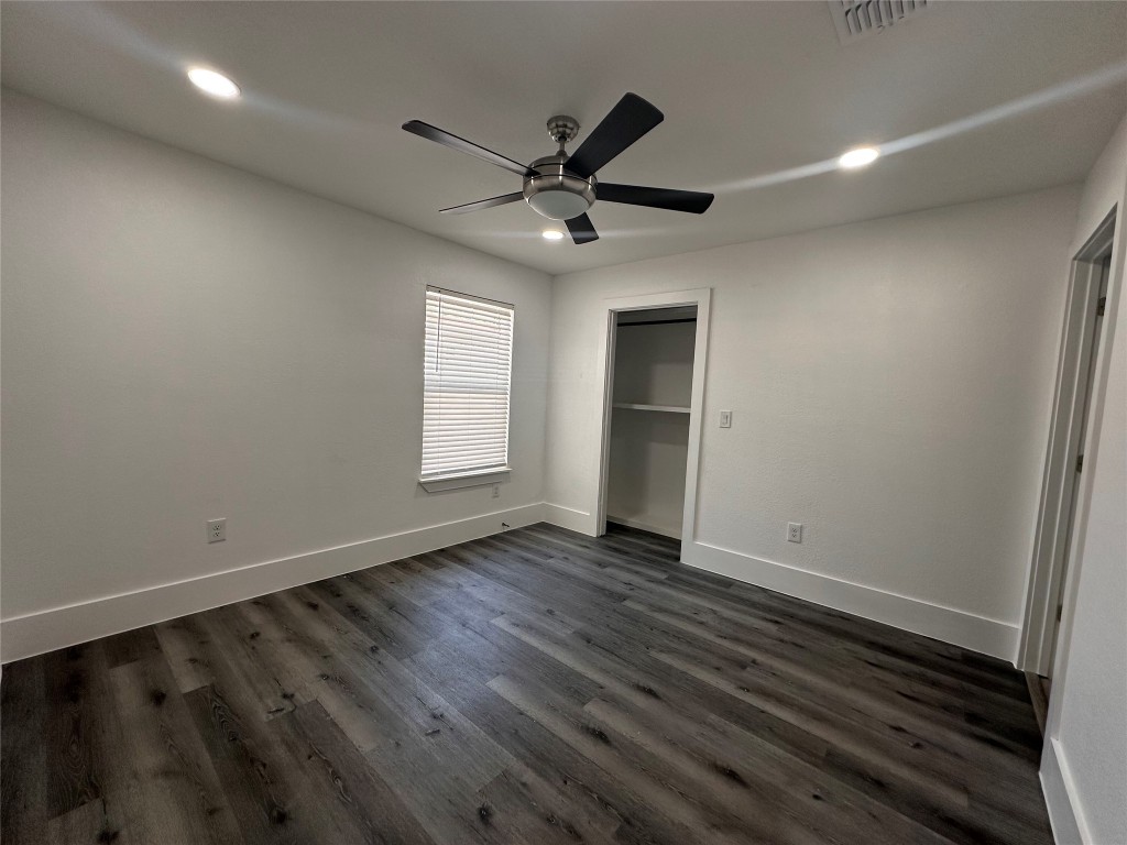 720 Neches Street Lockhart, TX 78644 - Photo 7 of 12 Primary bedroom featuring dark wood-type flooring, recessed lighting, a ceiling fan, and a closet