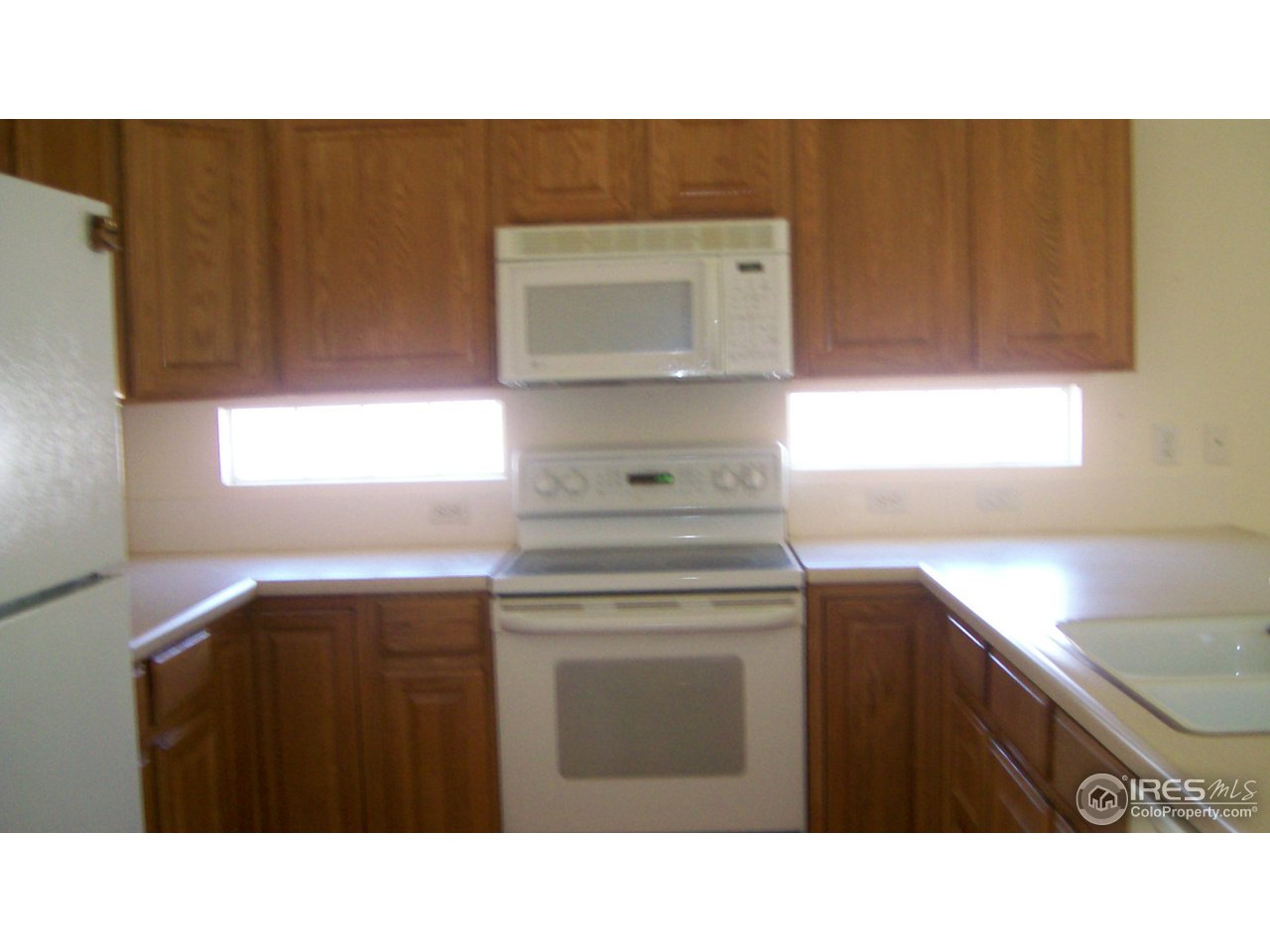 3597 West 21st Street Road Greeley, CO 80634 - Photo 2 of 12 a kitchen with a sink cabinets and window