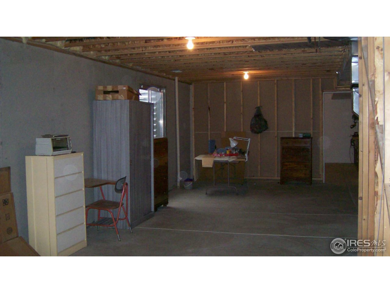 3597 West 21st Street Road Greeley, CO 80634 - Photo 7 of 12 a living room with furniture and a chandelier