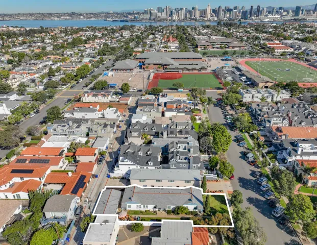 an aerial view of residential houses with outdoor space