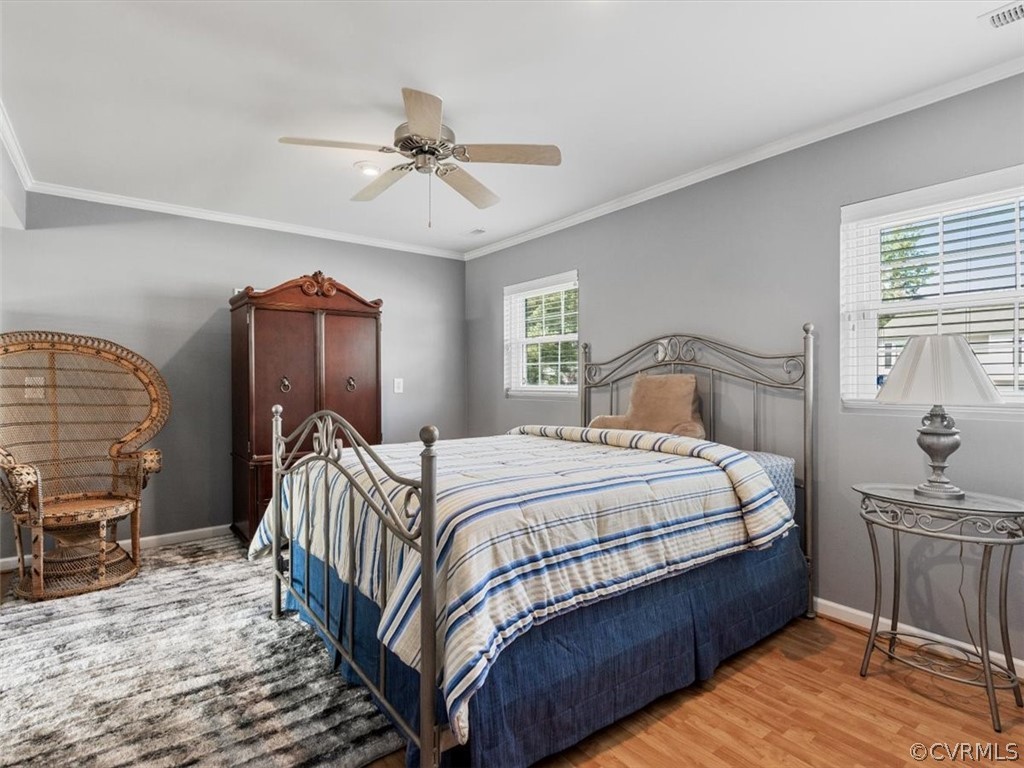 6601 Brambleton Road Chesterfield, VA 23832 - Photo 17 of 34 a bedroom with a bed and wooden floor