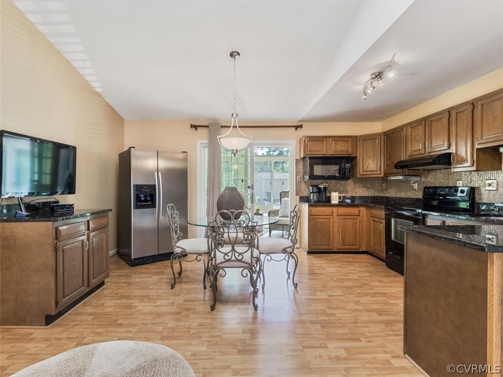 6601 Brambleton Road Chesterfield, VA 23832 - Photo 8 of 34 a kitchen with stainless steel appliances granite countertop a refrigerator a stove top oven a sink dishwasher a dining table and chairs with wooden floor