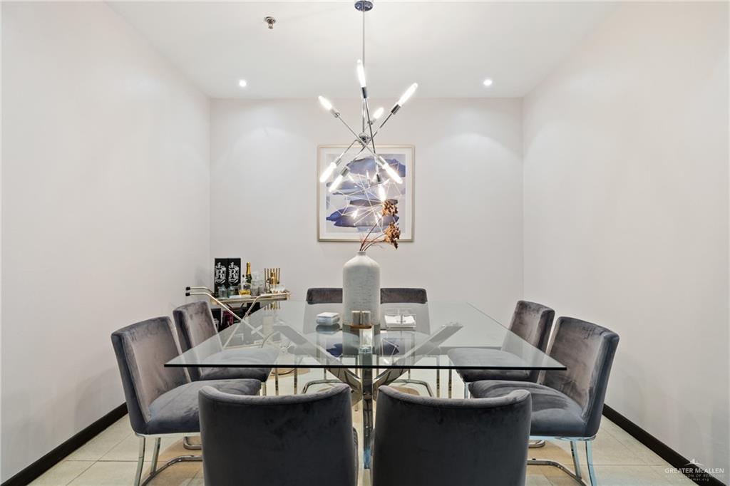 813 Travis Street, Unit 203 Mission, TX 78572 - Photo 10 of 30 a view of a dining room with furniture and chandelier