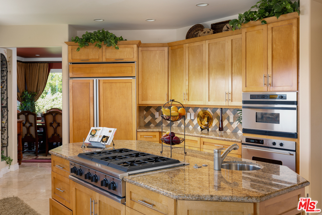 24533 Desert Avenue Newhall, CA 91321 - Photo 11 of 48 a kitchen with a stove and a refrigerator