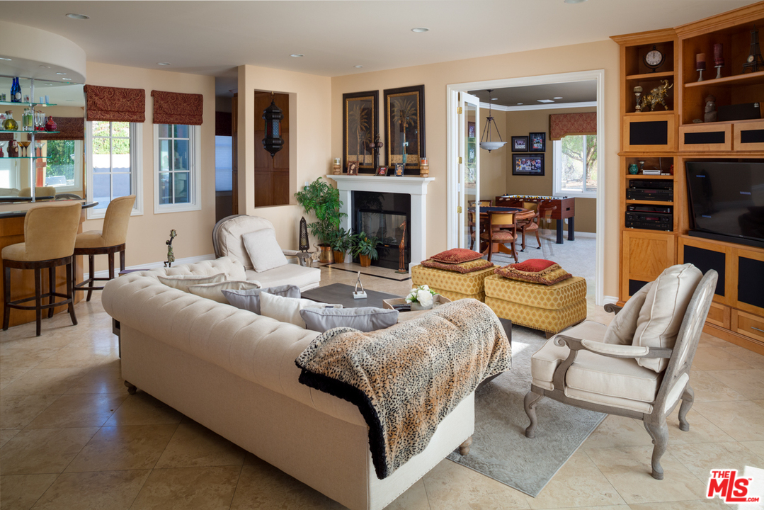 24533 Desert Avenue Newhall, CA 91321 - Photo 21 of 48 a living room with furniture and a fireplace