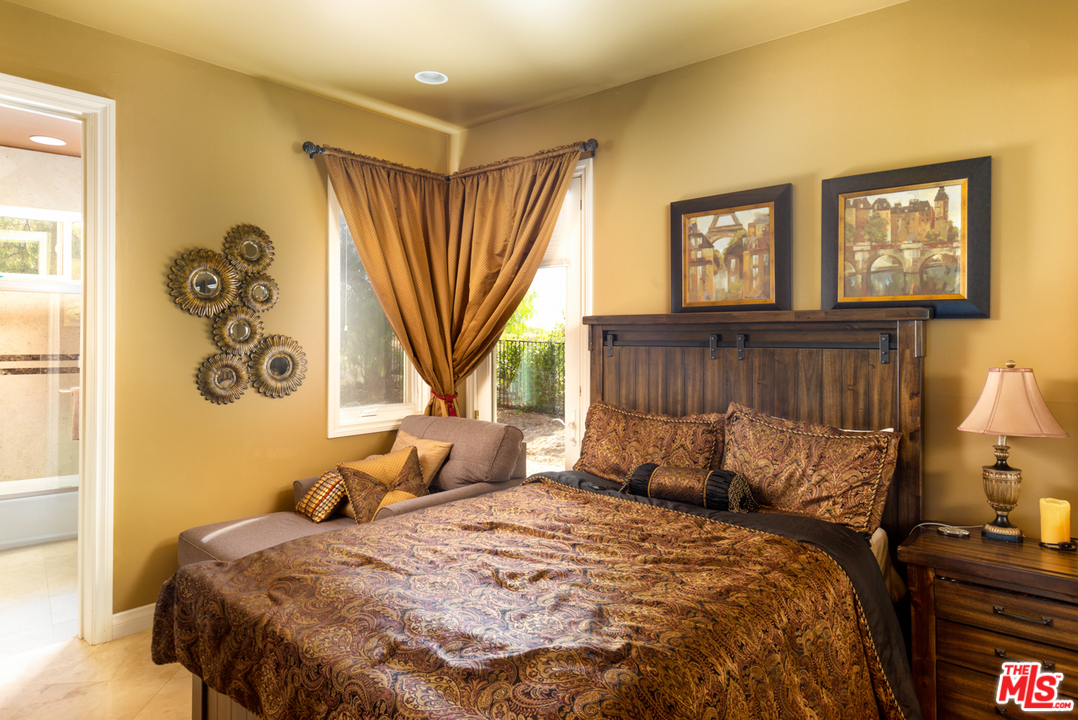 24533 Desert Avenue Newhall, CA 91321 - Photo 22 of 48 a bed sitting in a bedroom next to a window