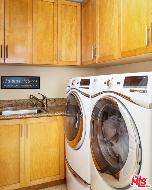 24533 Desert Avenue Newhall, CA 91321 - Photo 23 of 48 a utility room with sink dryer and washer
