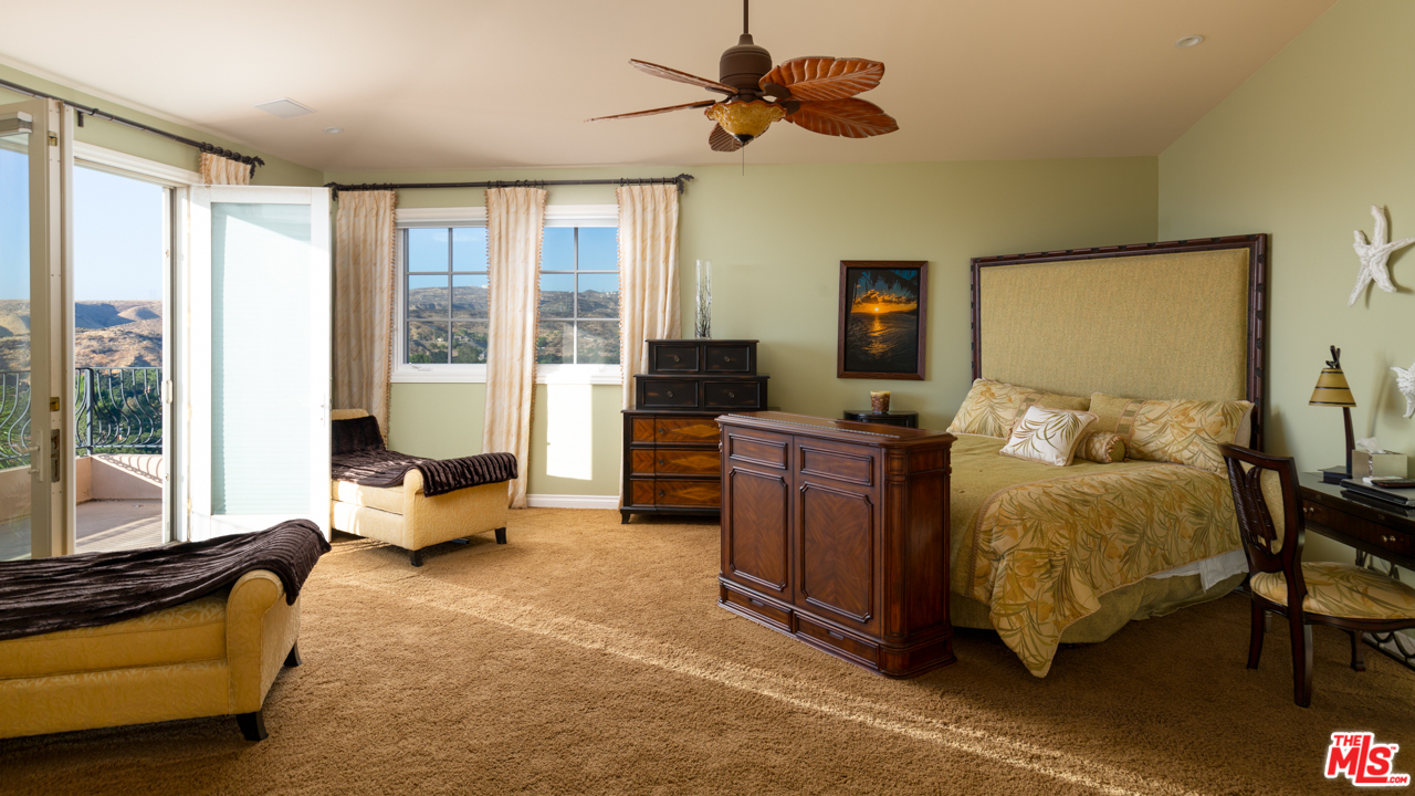 24533 Desert Avenue Newhall, CA 91321 - Photo 38 of 48 a spacious bedroom with a bed and large windows