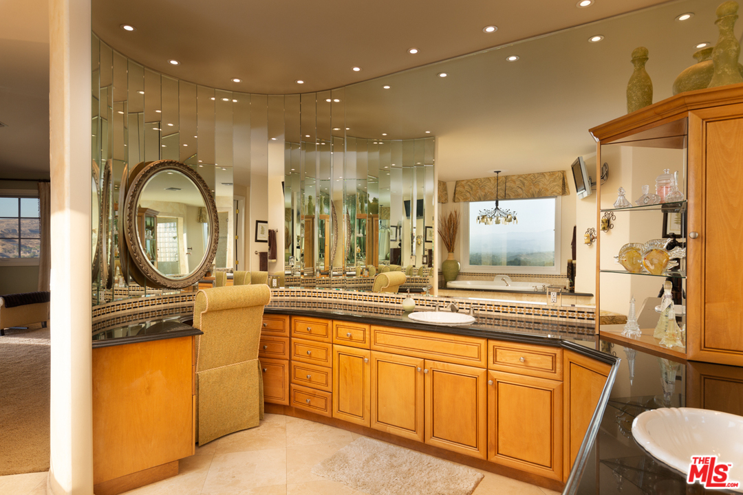 24533 Desert Avenue Newhall, CA 91321 - Photo 40 of 48 a bathroom with a sink a toilet and a shower