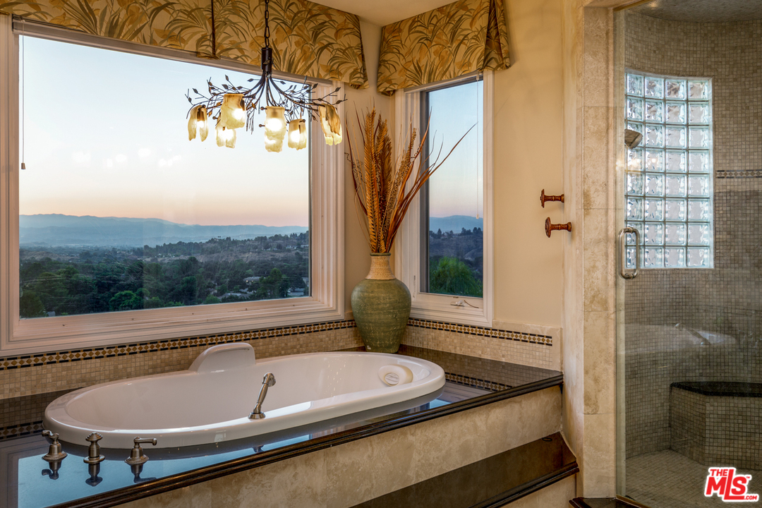 24533 Desert Avenue Newhall, CA 91321 - Photo 42 of 48 a bathroom with a granite countertop sink and bathtub