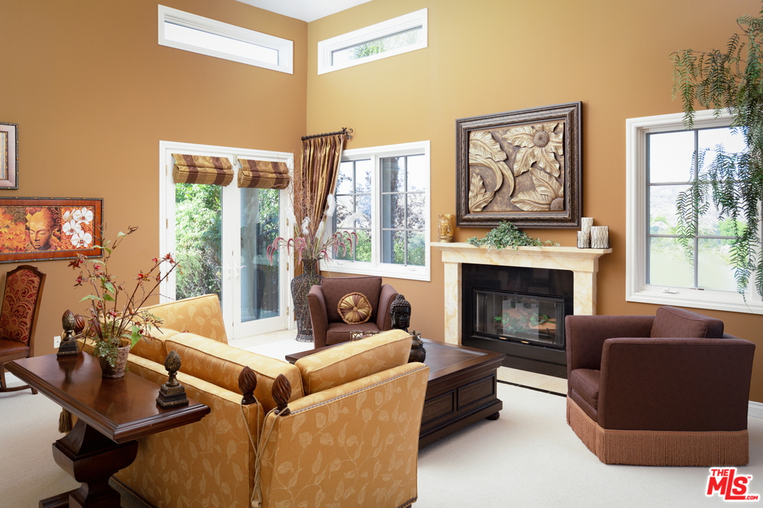 24533 Desert Avenue Newhall, CA 91321 - Photo 7 of 48 a living room with furniture large window and a fireplace