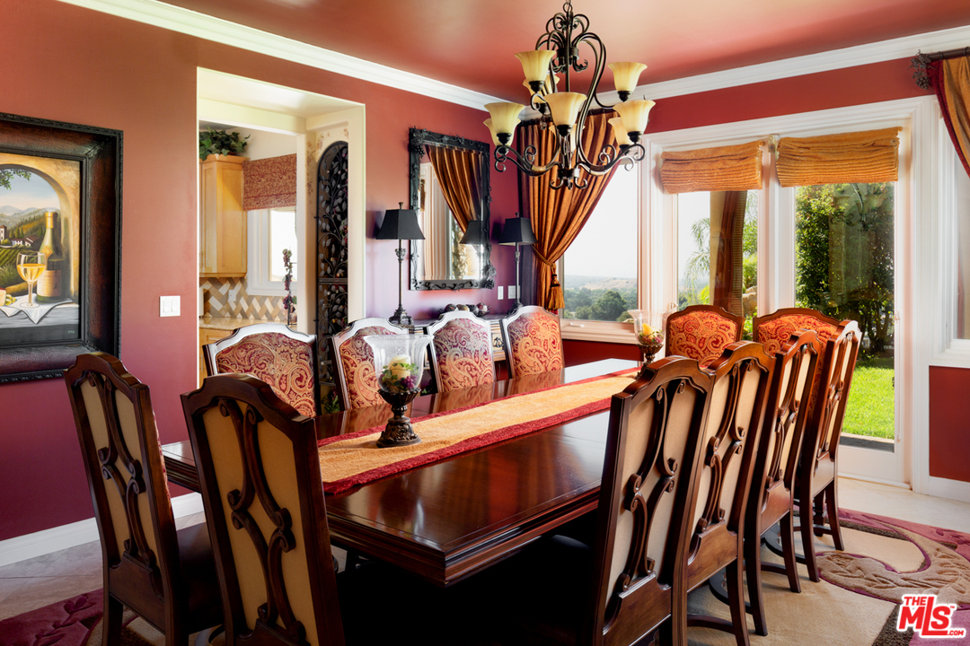 24533 Desert Avenue Newhall, CA 91321 - Photo 9 of 48 a view of a dining room with furniture a chandelier and large windows