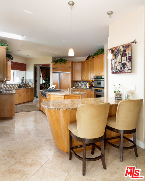 24533 Desert Avenue Newhall, CA 91321 - Photo 10 of 48 a living room with stainless steel appliances kitchen island granite countertop furniture and a kitchen view