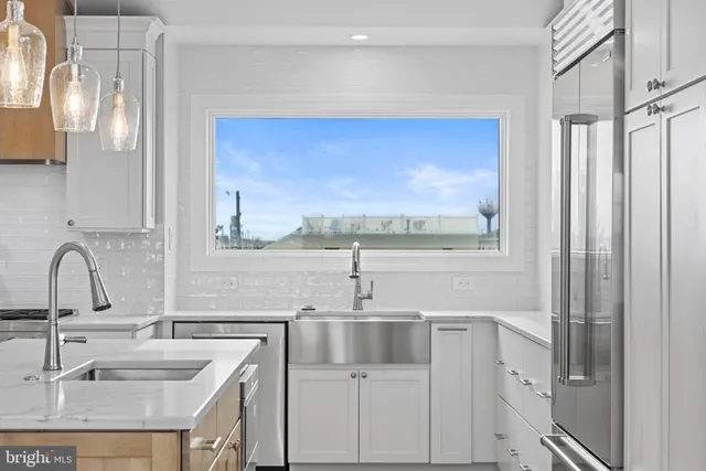 a kitchen with cabinets appliances and a sink