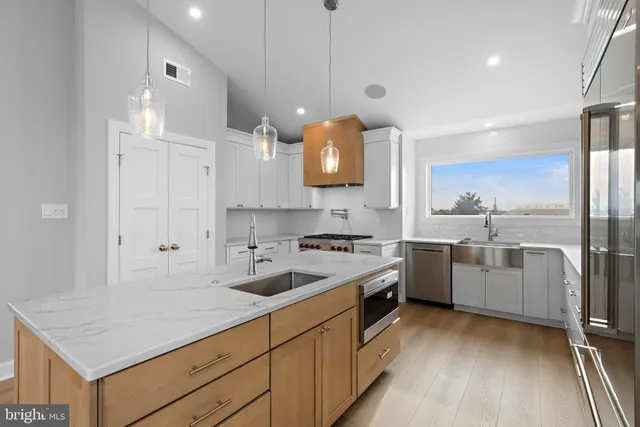 a kitchen with a stove a sink and a refrigerator