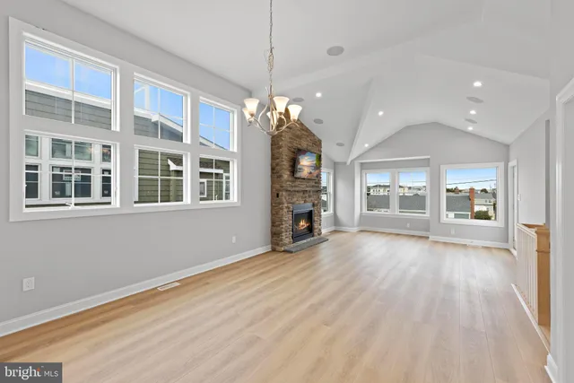 a view of a hallway with a fireplace and window