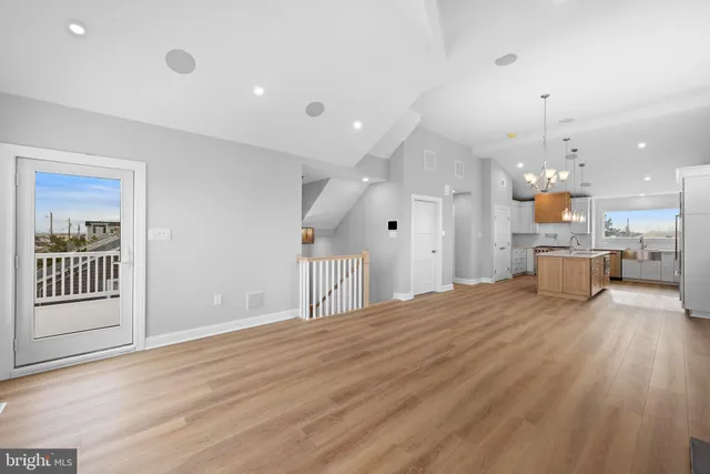 a view of a hallway to a bedroom with wooden floor