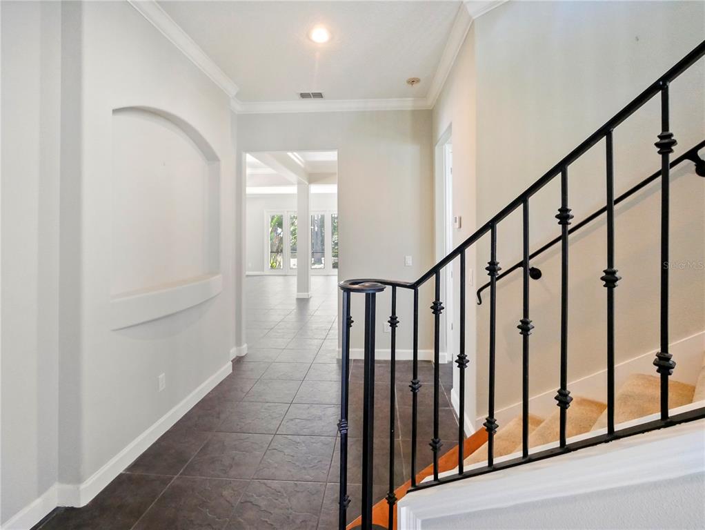 7710 Linkside Loop Reunion, FL 34747 - Photo 17 of 33 a view of staircase with lots of frames on wall and stairs